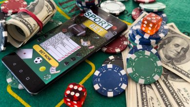 A smartphone showing an online gambling site surrounded by money and casino coins