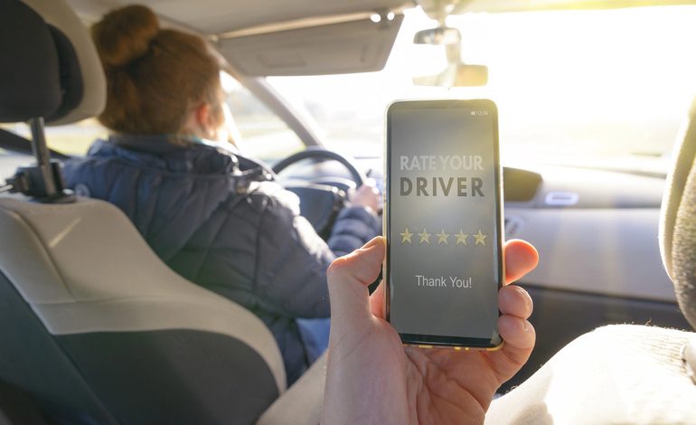 A smartphone displaying a ridesharing app and a rideshare driver