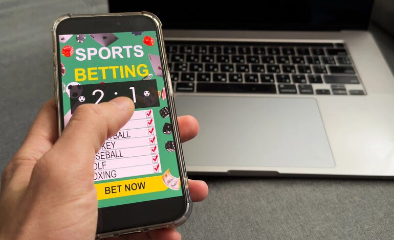 A man is betting on an online casino website on his smartphone.