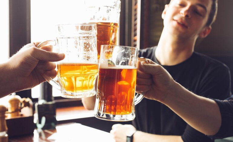 A group of friends is drinking beer in a bar.