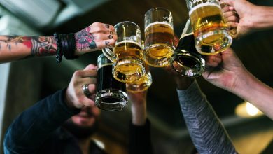 A group of friends is drinking craft beer at a bar.