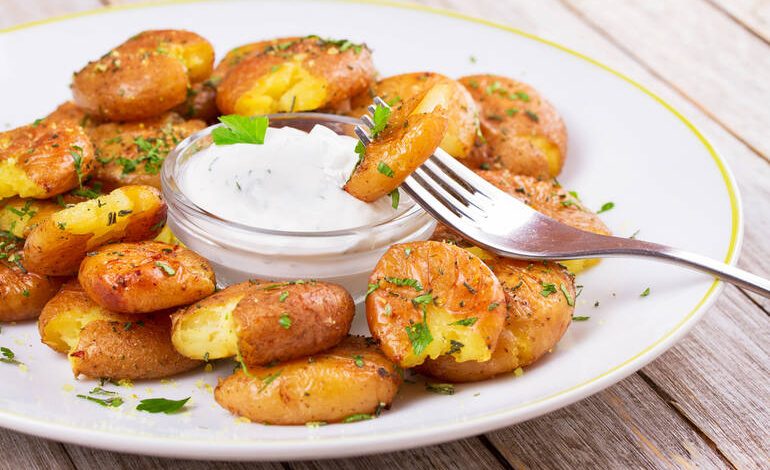 Crispy smashed homegrown potatoes served as bar-style appetizers with dipping sauce.