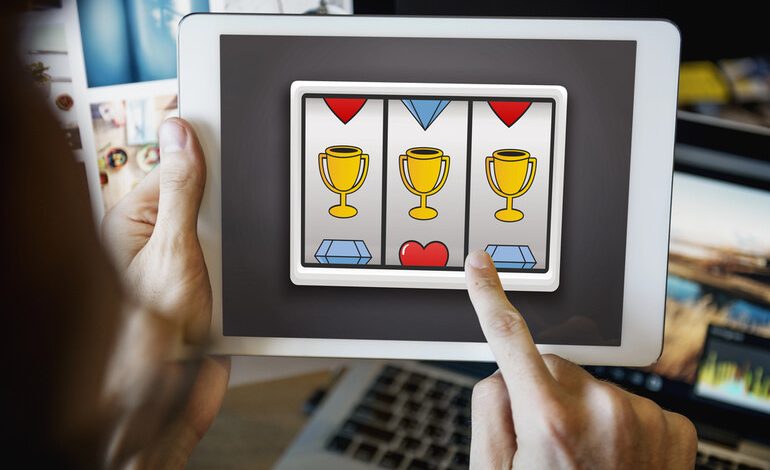 A man is playing an online slot game on a digital device