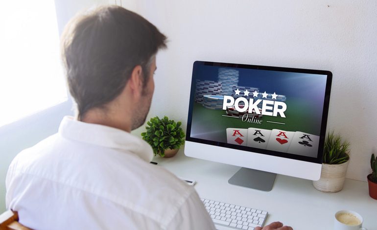 A man is playing online casino on a desktop computer.