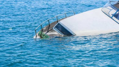 Partially submerged boat after an accident on open water, illustrating the risks and legal complexities of boating incidents.”