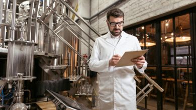 Brewery owner reviewing employee documents inside a brewery.
