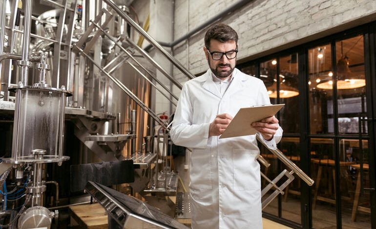 Brewery owner reviewing employee documents inside a brewery.