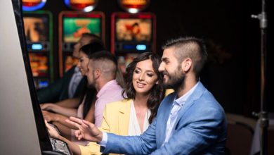 Stylish couple enjoying slot machines at a modern casino, reflecting the sleek and social vibe of WS Casino Australia for beer-loving players.