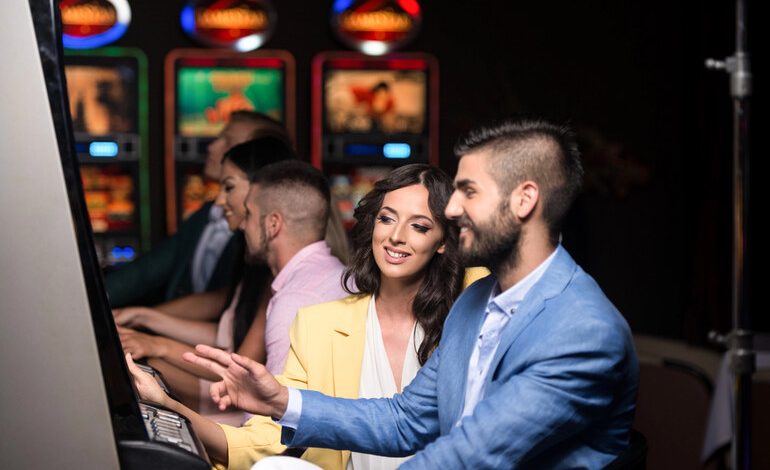 Stylish couple enjoying slot machines at a modern casino, reflecting the sleek and social vibe of WS Casino Australia for beer-loving players.