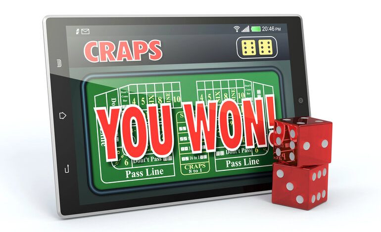 Tablet showing an online craps game with “You Won” and red dice in front.