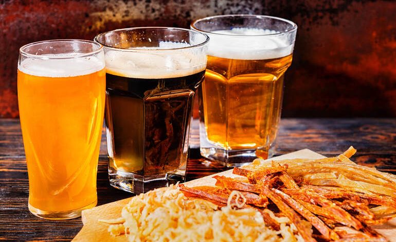 Beer in glasses, 3 types of beer included a hazy pale brew, a dark stout, and a golden lager.