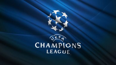 UEFA Champions League logo on a blue flag background.