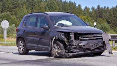 Damaged SUV after front-end collision on a rural road, deployed airbags visible, highlighting car accident impact and vehicle safety risk.