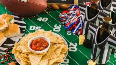 Bottles of beer with snacks on a table, game day setup for watching NFL Sundays at a craft beer bar in San Diego.